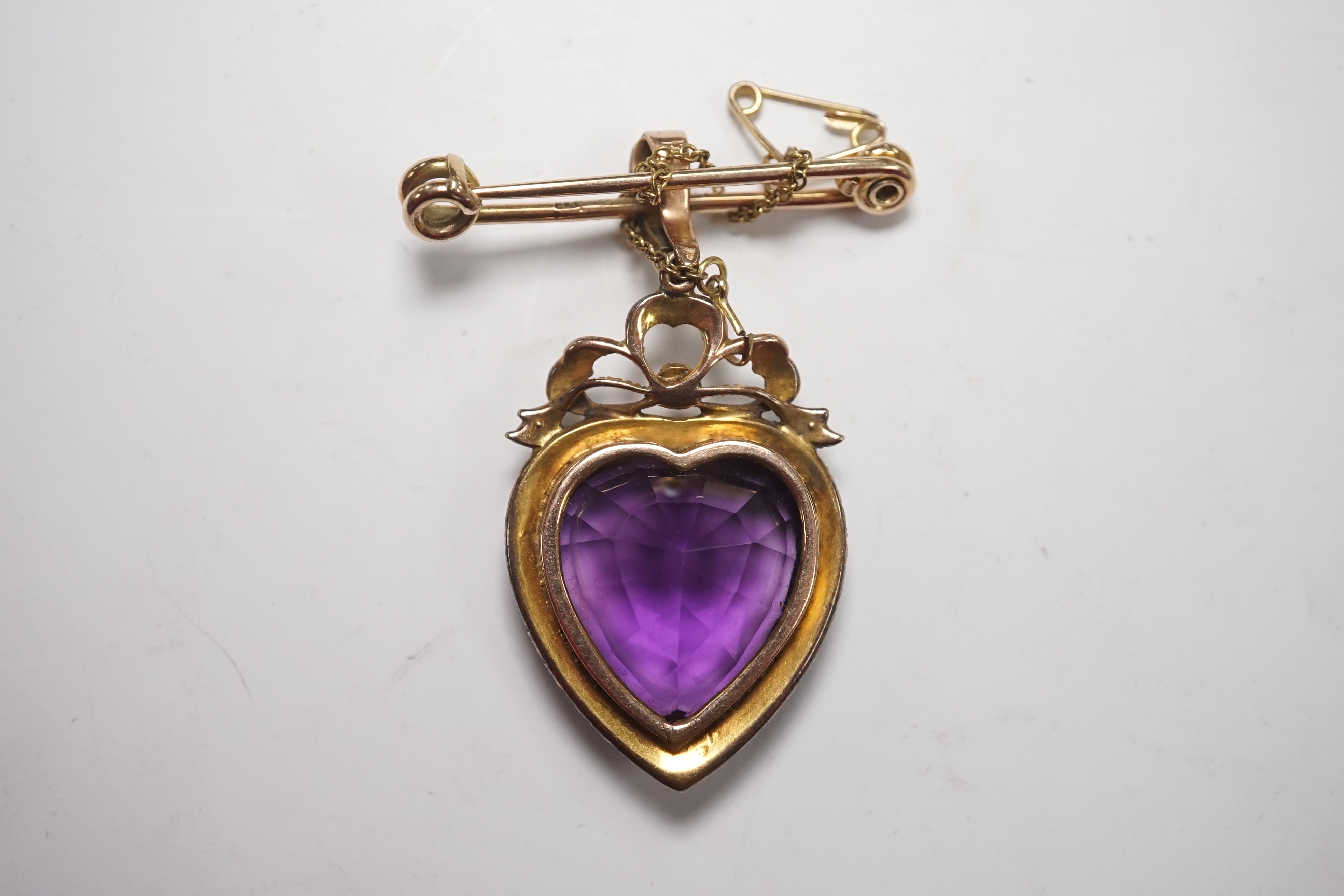 A late Victorian yellow metal amethyst and split pearl cluster set heart shaped pendant, overall 48mm, with later attached 9ct gold brooch attachment, gross weight 14 grams. Condition - fair to good